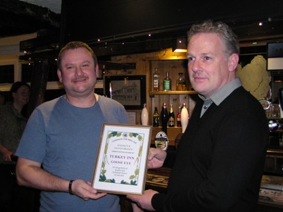 CAMRA Branch member, Mark Whiteley presents licensee Mark Shelley of the Turkey, Goose Eye with an Improved Pub award on 20th November 2012