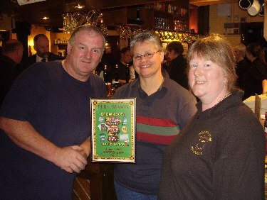 Colleen presents Barry and Carol with the Pub of the Season plaque