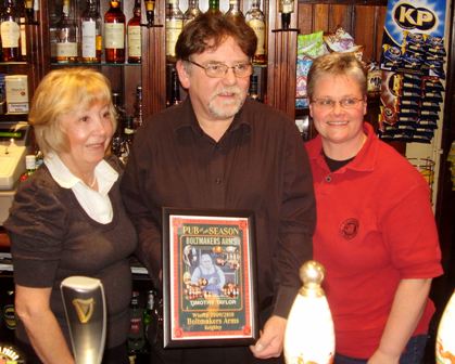 Chairperson Colleen (right) presents the award to Val and Phil Booth.
